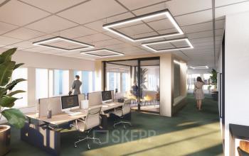 Modern office interior at Herikerbergweg 288, Amsterdam South East. Features an open floor plan with stylish lighting, sleek desks, and a meeting room. Ideal workspace for businesses seeking office space rental.