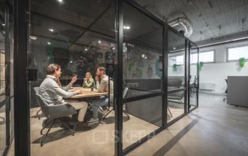 Office space at Luttenbergweg 8, Amsterdam South East with people in a meeting room. Ideal for office space rental.