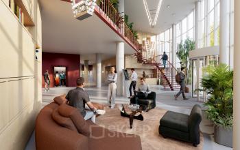 Interior view at Luttenbergweg 8, Amsterdam South East, showcasing a modern, furnished office space rental with people engaging in business activities like meetings and discussions.