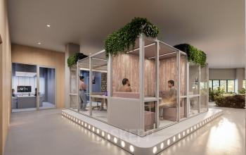 Modern office space at Luttenbergweg 8, Amsterdam South East, featuring stylish furniture and people engaged in collaborative discussions.