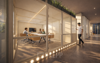 Office space rental at Luttenbergweg 8, Amsterdam South East, featuring a glass-enclosed meeting room where individuals discuss business matters.