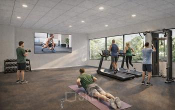 A modern fitness area with individuals engaging in workout activities, including weightlifting, treadmill exercises, and yoga, ideal for those renting office space seeking health facilities.