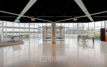 Spacious interior at Luttenbergweg 8, Amsterdam South East, featuring modern design with two desks. Ideal for office space rental.