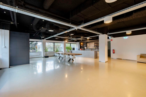 Bright and spacious open floor plan at Luttenbergweg 8, Amsterdam South East, ideal for office space rental with modern furnishings and large windows offering natural light.
