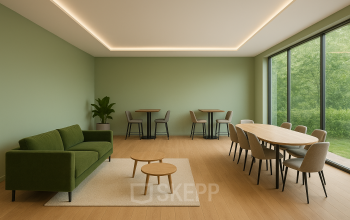 Spacious office interior at Johan Cruijff Boulevard 89, Amsterdam South East, featuring modern furniture including a green sofa and tables, ideal for office space rental.