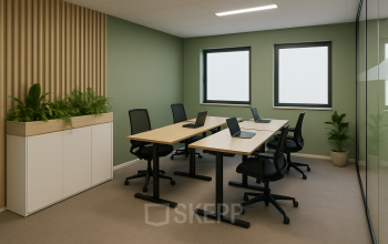 Bright furnished office space at Johan Cruijff Boulevard 89, Amsterdam South East available for rent, featuring desks with laptops, chairs, and indoor plants.