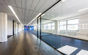 Office space for rent at Paasheuvelweg 20 20 in Amsterdam South East, featuring spacious interiors with large windows and glass walls.