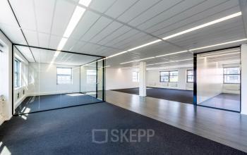 Spacious office to rent at Paasheuvelweg 20 20, in Amsterdam South East, featuring a large open floor plan with glass partitions and ample natural light.