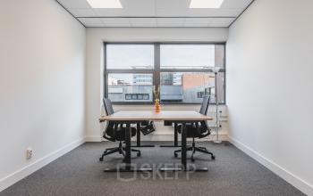 Furnished office space with two desks and chairs at Paasheuvelweg 20, Amsterdam South East, suitable for rent.