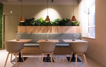 Modern office space at Hullenbergweg 109-135 in Amsterdam South East, featuring a stylish, furnished lounge area with plants and seating, available for rent.