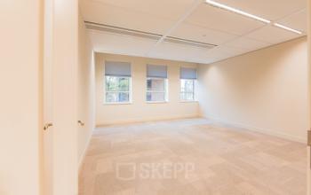 Empty office space with large windows at Hullenbergweg 109-135, suitable for office space rental in Amsterdam South East.