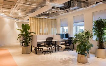 Modern office space with workstations and greenery at Hullenbergweg 109-135, Amsterdam South East, ideal for office space rental.