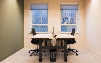 Bright office space with two desks, modern chairs, and large windows, available for rental at Hullenbergweg, Amsterdam South East.