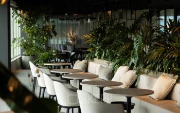 Modern office space with elegant furnishings, plants, and comfortable seating located at Herikerbergweg 290, Amsterdam South East, available for office space rental.