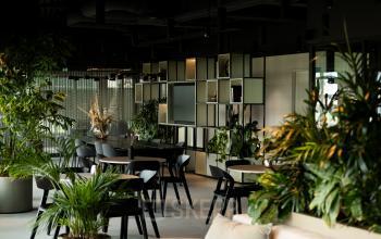 Modern office space located on Herikerbergweg 290 in Amsterdam South East, featuring lush greenery and contemporary furnishings available for office space rental.