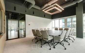 Modern furnished conference room at Herikerbergweg 290, Amsterdam South East, ideal for office space rental with a sleek design and large table.