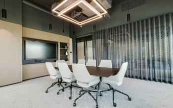 Modern conference room at Herikerbergweg 290, Amsterdam South East, featuring a sleek table and chairs, ideal for office space rental.