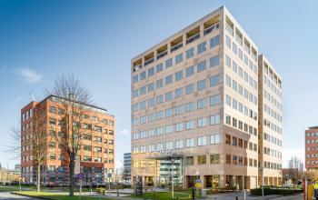 Exterior view of the office buildings located at Karspeldreef 8, Amsterdam South East, showing the modern architecture and surrounding area.