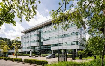 Exterior view of a modern office building located at Burgemeester Stramanweg 102, Amsterdam South East, ideal for office space rental.