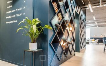 Modern office interior with geometric shelving at Burgemeester Stramanweg 102, Amsterdam South East. The stylish design enhances this office space rental with functional decor.