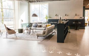 Modern and stylish lounge area at Burgemeester Stramanweg 102 in Amsterdam South East, featuring cozy seating, large windows, and chic decor, ideal for office space rental needs.