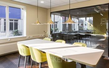 Modern conference room in Amsterdam South East with natural light and sleek furnishings, ideal for office space rental.
