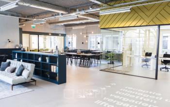 Modern open-plan office space in Amsterdam South East featuring stylish workstations, a cozy lounge area, and plenty of natural light. Ideal for those seeking office space rental with a vibrant atmosphere.