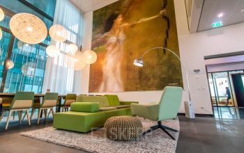 Bright Amsterdam South East office space for rent at Herikerbergweg 292, featuring vibrant furnishings and modern decor, ideal for office space rental.