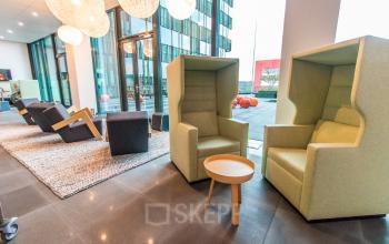 Modern office to rent at Herikerbergweg 292, Amsterdam South East, featuring cozy seating and open space for office space rental.