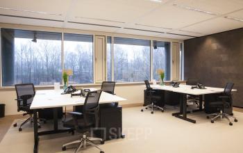 Spacious office to rent at De Entree 99-197, Amsterdam South East, featuring modern desks, ergonomic chairs, and large windows with a view.