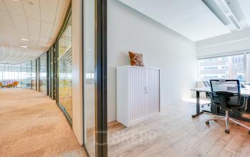 Bright office space for rent with large windows and modern furnishings, located at De Entree 99-197 in Amsterdam South East.