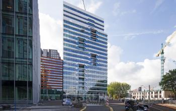 Elegant facade of a modern office space rental at Parnassusweg 819 in Amsterdam Zuidas, with dynamic architectural design.