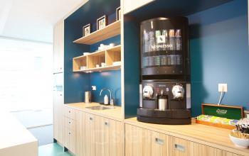 Stylish pantry with coffee machine and snacks at Parnassusweg 819 office space rental in Amsterdam Zuidas.