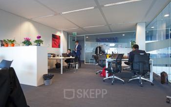 Spacious office space rental at Parnassusweg 819, Amsterdam Zuidas, with professionals focused on business activities.