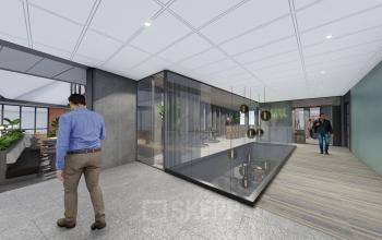 Modern interior office space rental at Jachthavenweg 109-A, Amsterdam Zuidas, with glass walls, stylish lighting, and people engaging in business activities.