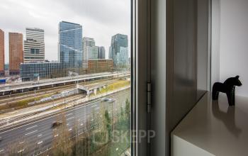 View from a window at Zuidplein 36 office space rental, showcasing Amsterdam Zuidas area.
