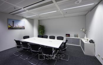 Modern office space rental at Zuidplein 36, Amsterdam Zuidas with a sleek conference room, equipped for business meetings.