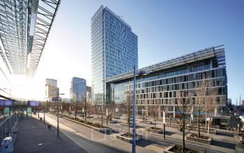 Office space rental available at Zuidplein 36 framed by modern architecture and clear blue skies in Amsterdam Zuidas.