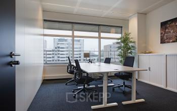 Modern office space rental at Strawinskylaan 3051, Amsterdam Zuidas, with ergonomic chairs and large windows offering plenty of natural light.