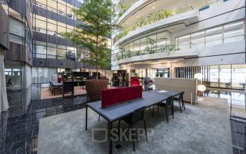 Modern office space rental at Strawinskylaan 3051, Amsterdam Zuidas with contemporary design and greenery.
