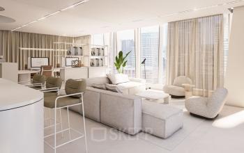 A modern, well-lit lounge area at Strawinskylaan 257, Amsterdam Zuidas, featuring stylish furnishings including plush seating and a sleek workstation. Ideal for those in search of office space rental.
