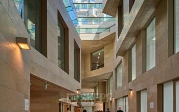 Modern atrium at Beethovenstraat 503, Amsterdam Zuidas, showcasing a blend of sleek architectural design and open, airy spaces, ideal for businesses seeking office space rental with natural lighting and stylish surroundings.
