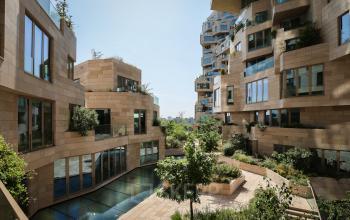 Exterior view of the office building at Beethovenstraat 503, Amsterdam Zuidas, featuring modern architecture and garden areas, ideal for those seeking office space rental.