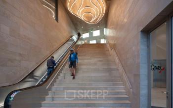 Entrance of the building at Beethovenstraat 503, Amsterdam Zuidas, featuring a modern staircase and sleek wall design, ideal for businesses seeking office space rental in a prime location.