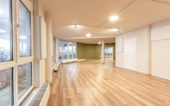 Unfurnished office space for rental at De Boelelaan 1110, Amsterdam Zuidas, featuring large windows allowing ample natural light and a wooden floor.