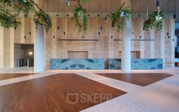 Spacious and elegant entrance at Hildegard Von Bingenstraat 44, Amsterdam Zuidas, ideal for office space rental. Modern design with high ceilings and sleek finishes.