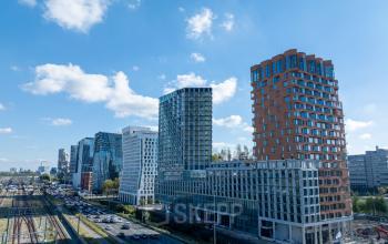 Exterior view of modern office buildings in Amsterdam Zuidas, showcasing potential office space rental at Hildegard Von Bingenstraat 44.