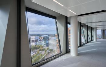 Spacious office in Amsterdam Zuidas, featuring large windows with impressive city views. Ideal for office space rental.
