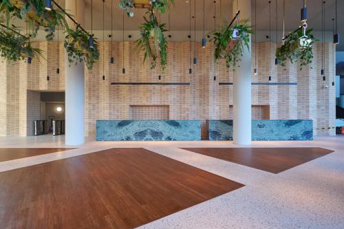 Spacious and elegant entrance at Hildegard Von Bingenstraat 44, Amsterdam Zuidas, ideal for office space rental. Modern design with high ceilings and sleek finishes.