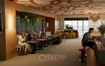 Modern office space at Barbara Strozzilaan 101 101 in Amsterdam Zuidas, featuring professionals collaborating in a stylish lounge area with seating and computer stations perfect for office space rental.